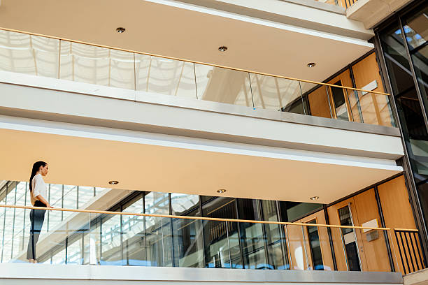 istock Elegant businesswoman walking inside building 610751884