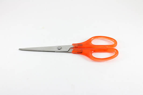 istock Close up orange scissors on white background isolated. 610752826