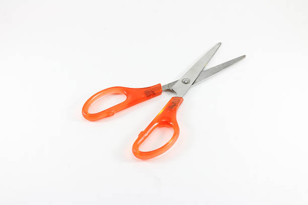 istock Close up orange scissors on white background isolated. 610752930