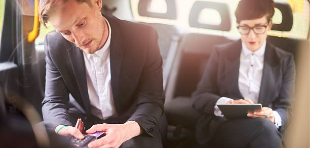 istock taxi commuters paying by card 610754996
