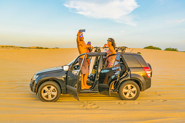 Jericoacoara, Brazil - December 30, 2015: Group of people taking a photo at dunes in Jericoacoara National Park in Brazil