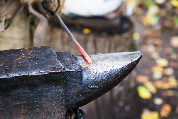 red hot heated iron rod on anvil
