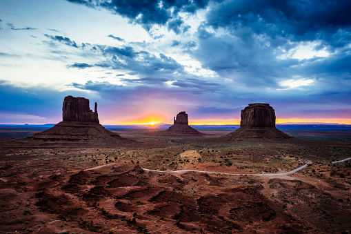 Dawn at Monument Valley Tribal Park with Beautiful Desert Sand in Front of the Majestic Mitten Bluffs of the Tribal Park