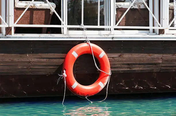 old lifebuoy hanging on a barge outdoor