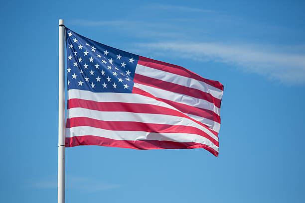 istock American flag Stars and Stripes blowing in the wind 610758424