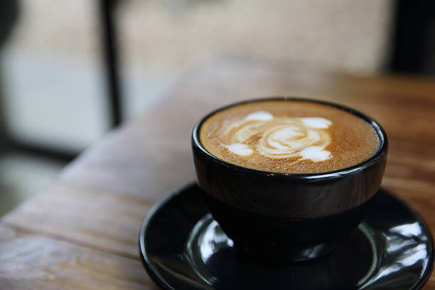 istock cappuccino coffee on wood background 610760300