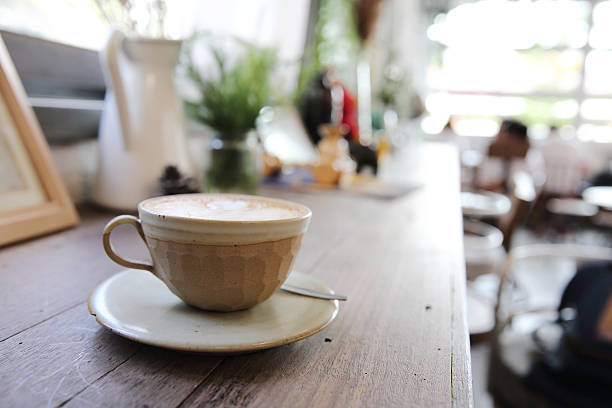 istock cappuccino coffee on wood background 610760638