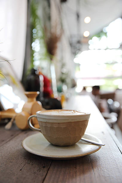 istock cappuccino coffee on wood background 610760706