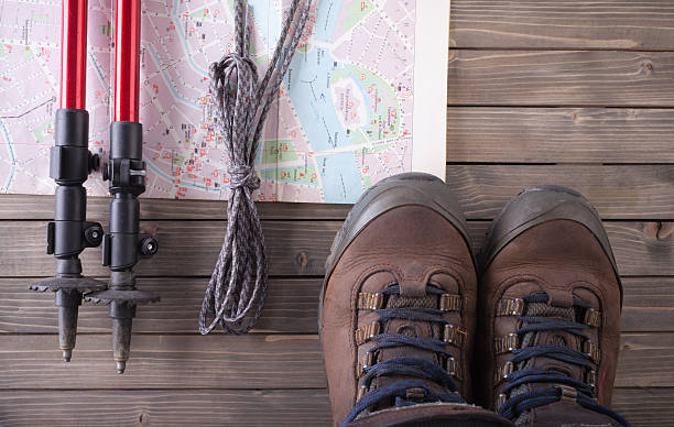 istock Equipment for hiking on a wooden floor background. 610761180