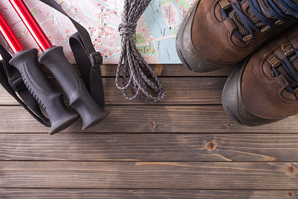 istock Equipment for hiking on a wooden floor background. 610761816