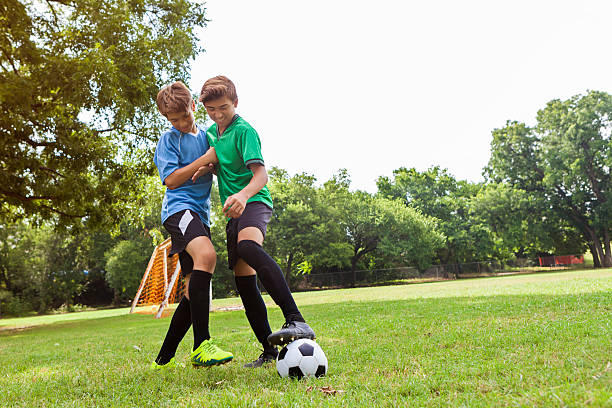 istock Boys fight over ball during soccer game 610765204