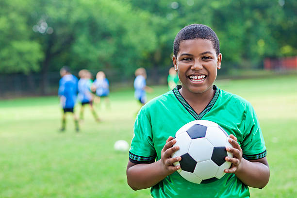 istock Handsome African American soccer player after winning game 610765692