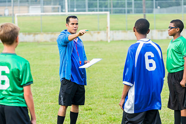 istock Hispanic soccer coach coaches players during game 610765732