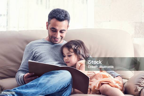 Little Girl And Father Reading Book Together Stock Photo - Download Image Now - Child, Father, Reading