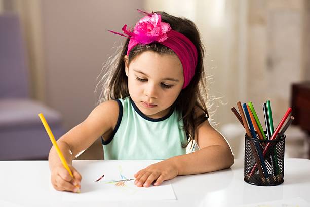 istock Little Girl Drawing Pictures 610766722