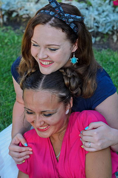 istock Two retro-style girls on a summer picnic posing 610768250