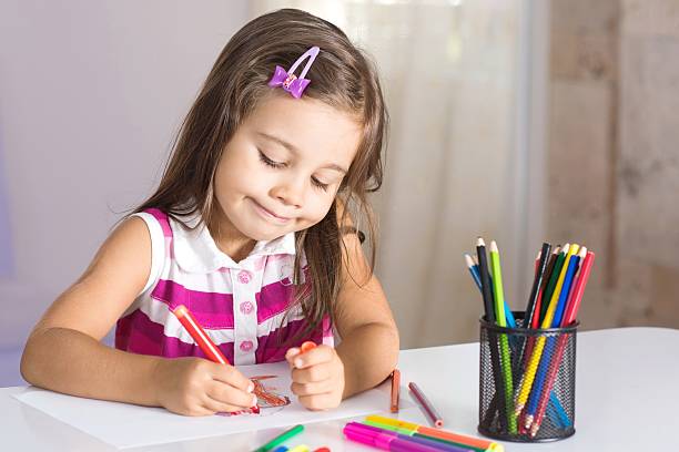 istock Little Girl Drawing Pictures 610770042