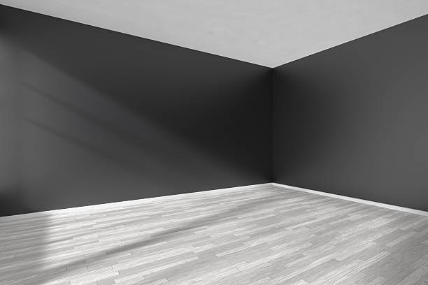 istock Corner of empty room with parquet floor and black walls 610770204