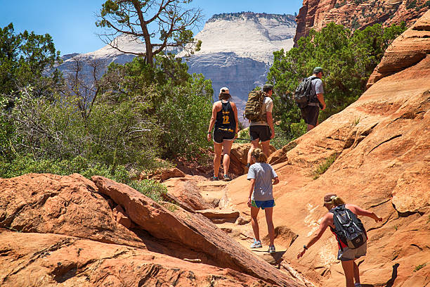 Zion, United States - June 22, 2015:  A family hiking a mountain trail in Zion National Park