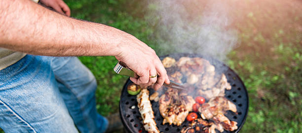 istock Man Cooking chicken batter On Barbecue 610774112