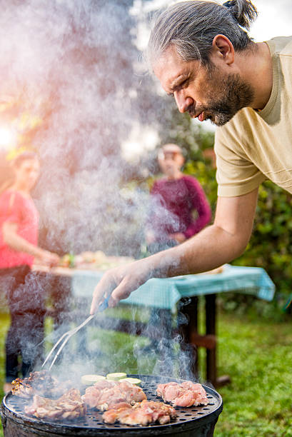 istock Man Cooking chicken batter On Barbecue 610774716
