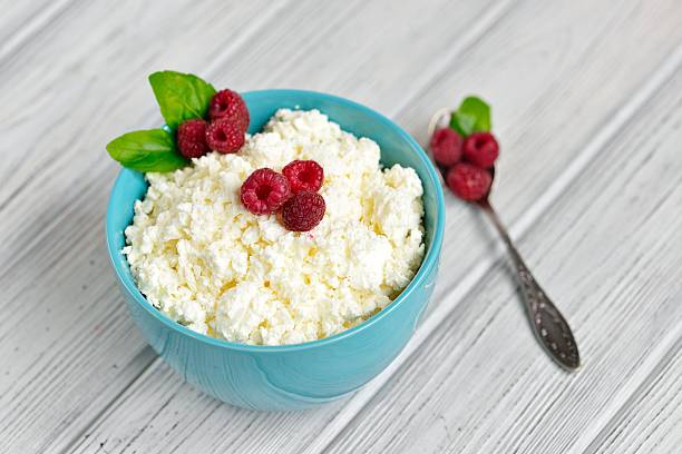istock Cottage cheese in blue bowl with raspberries and mint on 610775484