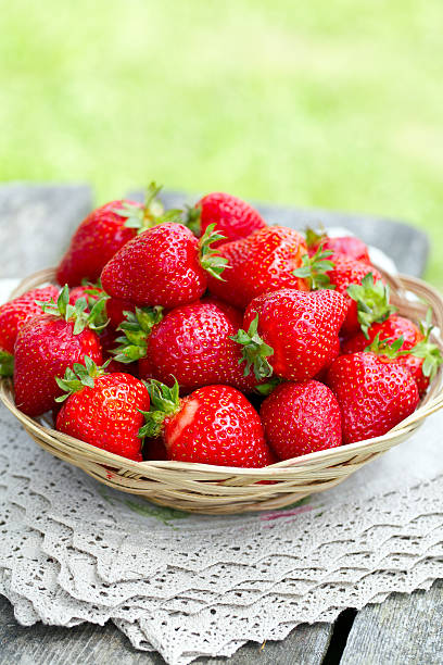 istock basket with strawberries on a garden wooden table 610776032