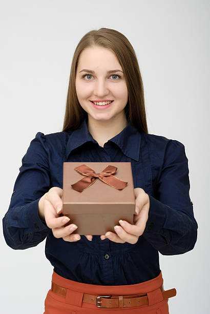 istock Young woman portrait holding gift 610777448
