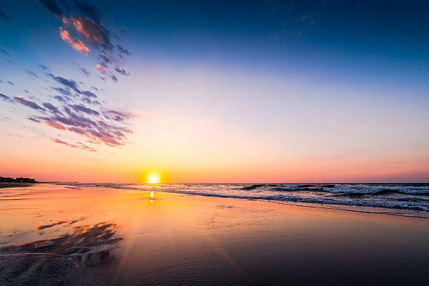 istock Colorful beach sunrise or sunset along the ocean shore 610777998