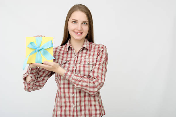 istock Young woman portrait holding gift 610778086