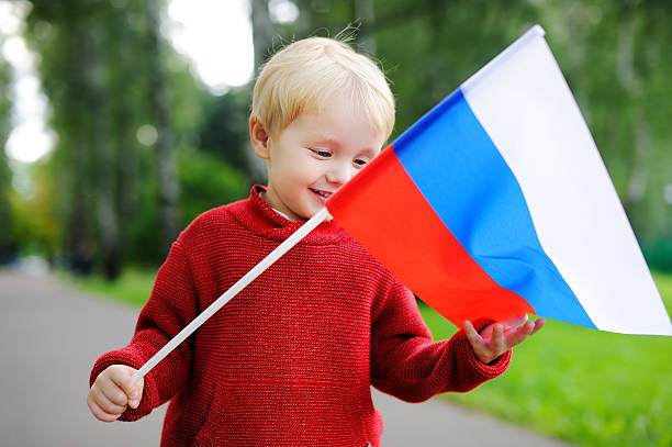 istock Toddler boy holding russian flag 610779540