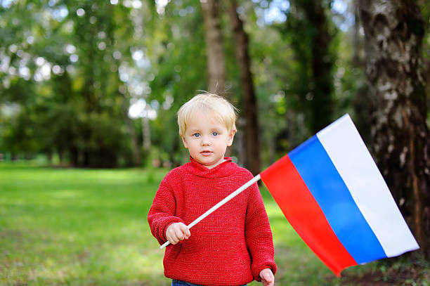 istock Toddler boy holding russian flag 610779740