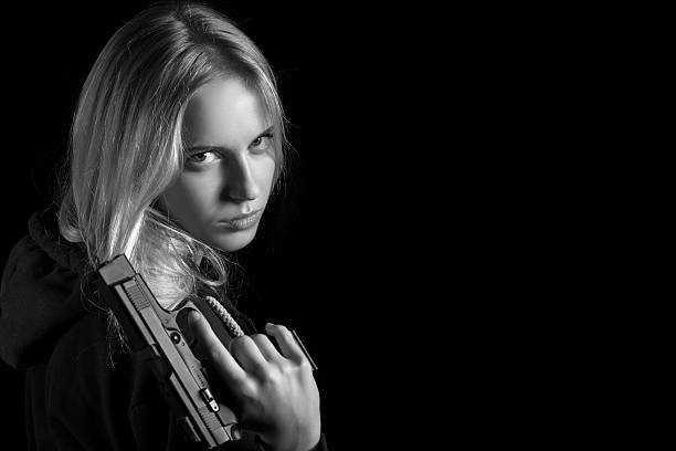 istock girl with gun 610780208