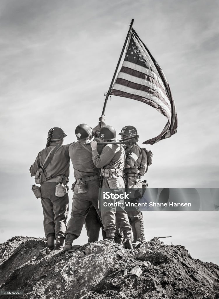 Soldiers Raising the US Flag Soldiers Raising the US Flag in celebration on top of a hill (Stock Image) World War II Stock Photo