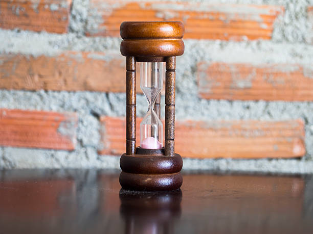 istock Closeup wooden hourglass ,stone background 610785354