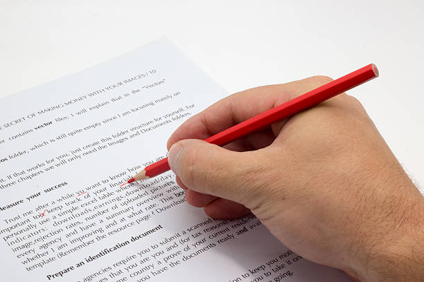 istock Hand doing proofreading on a faulty text with red pen 610785452