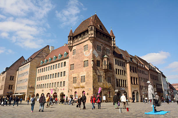 Street view in Nuremberg Nuremberg, Germany – April 10, 2016. Historic building on the intersection of Karolinenstrasse and Koningstrasse in Nuremberg, with commercial properties on the ground floor and people.  karolinenstrasse stock pictures, royalty-free photos & images