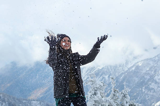 istock woman playing with snow 610786444