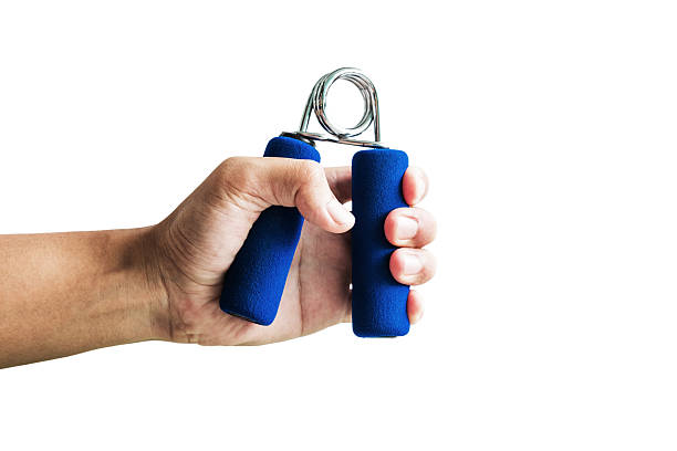 istock Close-up a man hand exercise by using hand gripper, isolated 610788376