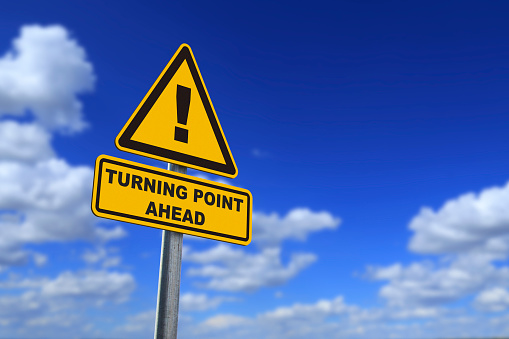 turning point ahead of road sign