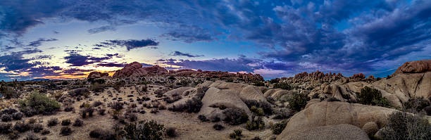 Desert at Night or Golden Hour Desert scene turing into night during sunset also called golden hour.  The sun has jsut set over the horizon so the skiles are vibrant with colors.  The image depicts nature and national parks in the Western America. mojave desert stock pictures, royalty-free photos & images
