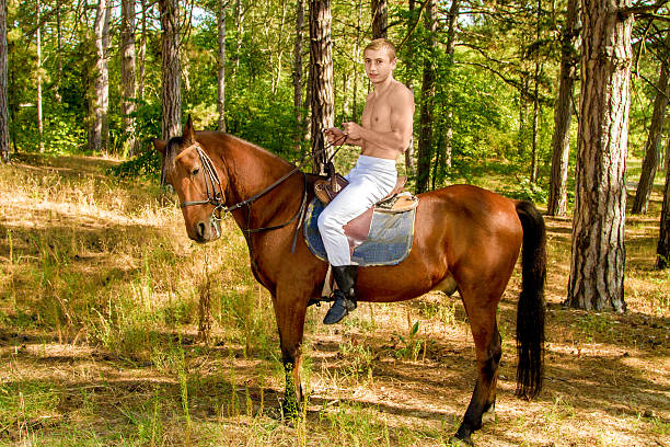 istock young man in the forest on horseback 610837890