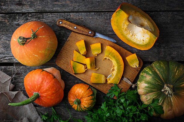istock Raw chopped pumpkin on wooden background 610841384
