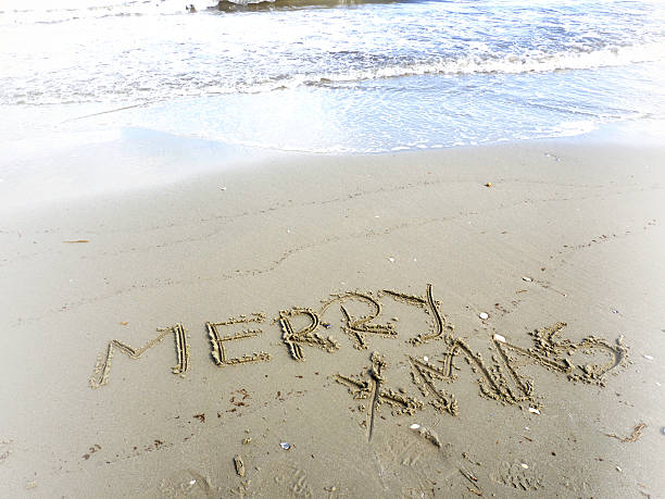 istock merry christmas written in sand 610841476