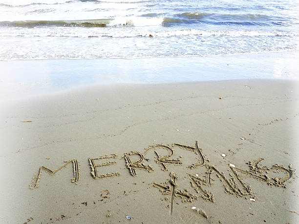 istock merry christmas written in sand 610841562