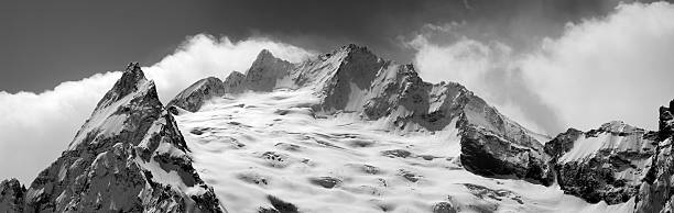 istock Black and white panorama of winter mountains 610843486