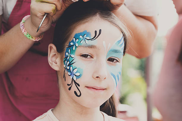 istock Female child face painting, making butterfly process 610845078