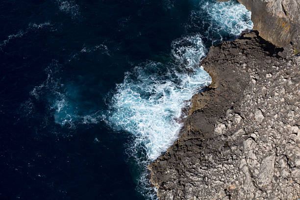 istock Blue sea, white foam and gray rock 610846266