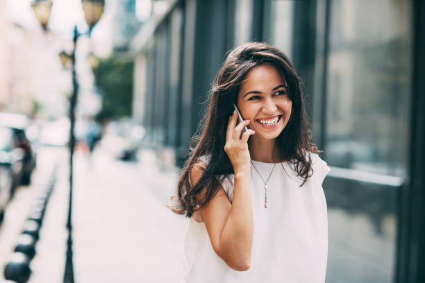 istock Cheerful girl talking on the phone 610846268