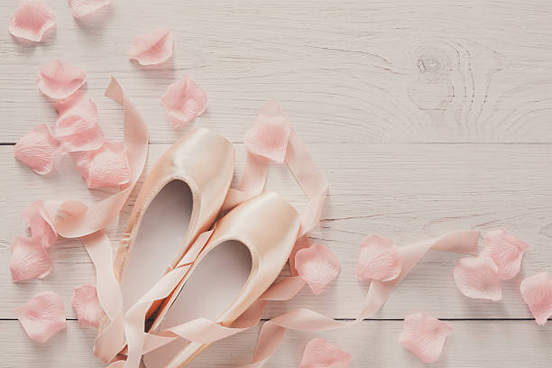 istock Pink ballet pointe shoes on white wood background 610847172